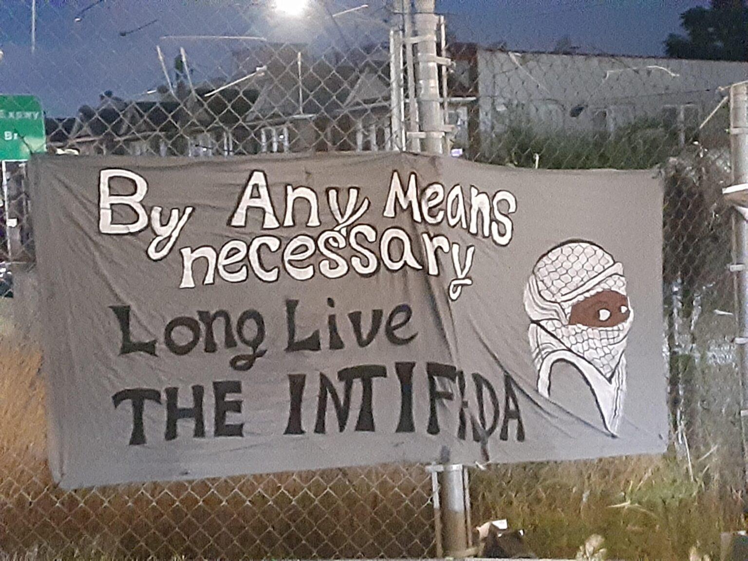 Banner reading "By any means necessary / Long live THE INTIFADA"